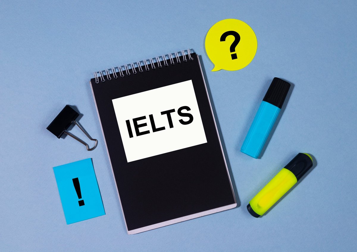 IELTS exam preparation materials with notebook, markers and stickers