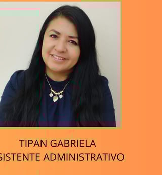 Portrait of Tipan Gabriela, an administrative assistant, smiling at the camera wearing a dark blue top and gold necklace