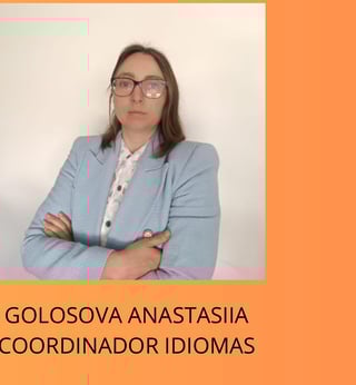Professional portrait of Golosova Anastasiia, Languages Coordinator, wearing glasses and light blue blazer with arms crossed against orange and white background