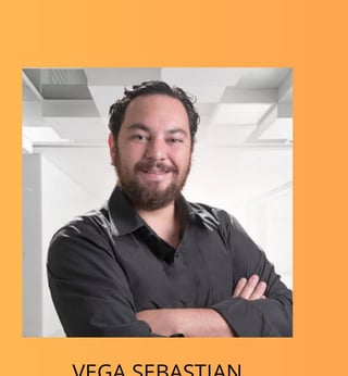 Portrait of Vega Sebastian, a man with dark hair and beard wearing a black button-up shirt, arms crossed, smiling in an office setting